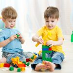 Kids boys play toys in playroom at nursery